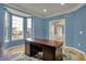 Study features a bay window, hardwood floors, elegant trim, and a stained wood desk at 9253 Windrift Way, Zionsville, IN 46077
