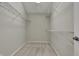 Empty walk-in closet ready to be organized with multiple wire racks for storage at 9253 Windrift Way, Zionsville, IN 46077