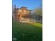 Two-story brick home featuring a wheelchair ramp, covered porch, and mature trees on a lush green lawn at 930 N Ritter Ave, Indianapolis, IN 46219