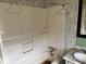 Bathroom with white tub surround, vintage vanity, and gray tile accents at 942 N Oxford St, Indianapolis, IN 46201