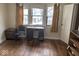 Bedroom featuring hardwood floors, desk, and natural light from several windows at 942 N Oxford St, Indianapolis, IN 46201