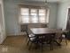 Dining room with built-in cabinets, large window, and dark wood table with seating at 942 N Oxford St, Indianapolis, IN 46201