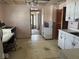 Spacious kitchen with white cabinets, linoleum flooring, and access to other rooms at 942 N Oxford St, Indianapolis, IN 46201