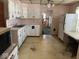 Kitchen with white cabinetry, vintage appliances, and dated flooring at 942 N Oxford St, Indianapolis, IN 46201