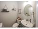 Charming half bath with trendy decor, floating shelves, and a unique mirror, adding a touch of personality at 10027 Landis Blvd, Fishers, IN 46040