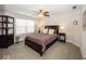 Comfortable bedroom with a ceiling fan, a dark wood frame bed, and a dark wood cabinet at 10027 Landis Blvd, Fishers, IN 46040
