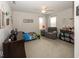 Bright bedroom with a comfortable chair and a dresser with framed photos and decorative ornaments at 10027 Landis Blvd, Fishers, IN 46040