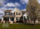 Charming two-story home with brick and siding exterior, black shutters and a covered front porch at 10027 Landis Blvd, Fishers, IN 46040