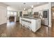 Modern kitchen with granite island, stainless appliances, and hardwood floors at 10027 Landis Blvd, Fishers, IN 46040