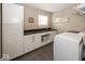 Functional laundry room with a washer, a countertop, and plenty of storage cabinets at 10027 Landis Blvd, Fishers, IN 46040