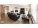 Comfortable living room showcasing a fireplace, hardwood floors, and ample seating at 10027 Landis Blvd, Fishers, IN 46040