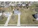 Aerial view of a home with a long driveway, surrounded by lush greenery, and neighboring houses at 10212 Ironway Dr, Indianapolis, IN 46239
