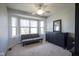 Bedroom with bay window, neutral carpet, ceiling fan and dark dresser with mirror at 10212 Ironway Dr, Indianapolis, IN 46239