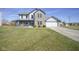 Charming two-story home with a well-manicured lawn, a cozy front porch, and an attached two-car garage at 10212 Ironway Dr, Indianapolis, IN 46239