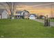 Charming two-story home with a combination of brick and siding and a large green lawn at 10212 Ironway Dr, Indianapolis, IN 46239