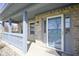 Charming front porch featuring a covered area, stylish railings, brick accents, and a glass front door for natural light at 10212 Ironway Dr, Indianapolis, IN 46239