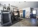 Garage showcasing home gym equipment, storage cabinets, and a side door for convenient access at 10212 Ironway Dr, Indianapolis, IN 46239