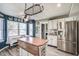 Spacious kitchen with island, stainless steel appliances, and adjacent dining area at 10212 Ironway Dr, Indianapolis, IN 46239