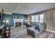 A comfortable living room featuring a fireplace, laminate flooring, and natural lighting at 10212 Ironway Dr, Indianapolis, IN 46239