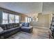 Spacious living room with large windows, wood floors, and a comfortable sectional sofa at 10212 Ironway Dr, Indianapolis, IN 46239