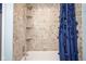 Tiled bathtub and shower space with built in shelves and a shower curtain at 10212 Ironway Dr, Indianapolis, IN 46239
