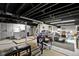 Spacious basement area with black painted ceiling, washer and dryer, and crafting space at 10427 N Delaware St, Carmel, IN 46280
