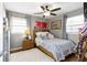 Cozy bedroom featuring a ceiling fan, warm wood floors, and decor over a comfortable bed at 10427 N Delaware St, Carmel, IN 46280