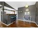 Cozy dining area with counter seating and adjacent table, showcasing a blend of modern and classic design at 10427 N Delaware St, Carmel, IN 46280