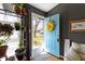 Inviting entryway showcasing a light blue door with decorative wreath, opening to the home's interior at 10427 N Delaware St, Carmel, IN 46280