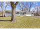Charming single-story home with stone accents, a light blue door, and a well-manicured front lawn at 10427 N Delaware St, Carmel, IN 46280