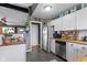 Well-lit kitchen with stainless steel appliances, white cabinets, and wooden countertops at 10427 N Delaware St, Carmel, IN 46280