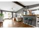 Open-concept living space with modern accents, hardwood floors, and seamless flow from living to kitchen area at 10427 N Delaware St, Carmel, IN 46280