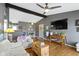 Open-concept living area with hardwood floors, a white sofa, and seamless flow to the dining and kitchen areas at 10427 N Delaware St, Carmel, IN 46280
