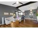 Comfortable living room featuring hardwood floors, neutral decor, and a seamless transition to the kitchen at 10427 N Delaware St, Carmel, IN 46280