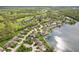 An aerial view shows homes nestled alongside a scenic lake and golf course, creating an idyllic community setting at 10725 Grindstone Dr, Fishers, IN 46037
