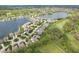 An aerial view features homes situated by a lake and a golf course in a thriving community at 10725 Grindstone Dr, Fishers, IN 46037