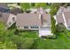 Aerial view of a tan home with a well-manicured lawn and a white deck at 10725 Grindstone Dr, Fishers, IN 46037