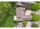 An aerial view of a tan house, showcasing its deck, landscaping, roof and surrounding lawn at 10725 Grindstone Dr, Fishers, IN 46037