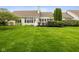 Large backyard showcasing lush green lawn, a well-maintained deck, and a variety of trees and shrubs at 10725 Grindstone Dr, Fishers, IN 46037