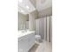 Bathroom with a white vanity, toilet, and shower/tub combo with a gray and white curtain at 10725 Grindstone Dr, Fishers, IN 46037