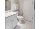 Bright, updated bathroom with a white vanity, toilet, shower, and fresh white towels at 10725 Grindstone Dr, Fishers, IN 46037