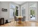 Bright breakfast nook featuring hardwood floors, a round wooden table, and access to the outdoor patio at 10725 Grindstone Dr, Fishers, IN 46037
