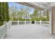 Expansive white deck surrounded by lush greenery, perfect for outdoor entertaining at 10725 Grindstone Dr, Fishers, IN 46037