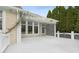 This covered deck area features a white pergola with climbing vines and outdoor space for dining and entertaining at 10725 Grindstone Dr, Fishers, IN 46037