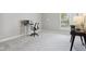 Bright home office featuring neutral walls, plush carpeting, and a modern adjustable height desk setup at 10725 Grindstone Dr, Fishers, IN 46037