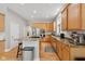 Well-equipped kitchen with granite countertops, stainless steel appliances, and wood cabinets at 10725 Grindstone Dr, Fishers, IN 46037