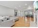 Open living room with hardwood floors, a comfortable sectional, and entry to the dining room at 10725 Grindstone Dr, Fishers, IN 46037