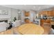 Open-concept living space with a fireplace, breakfast table, bar, and kitchen with stainless steel appliances at 10725 Grindstone Dr, Fishers, IN 46037