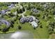 Aerial view of grand estate featuring a backyard pool, scenic pond, and lush landscaping at , Carmel, IN 46032