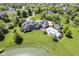 Luxury estate aerial view featuring a stunning backyard pool area and a tranquil pond at , Carmel, IN 46032